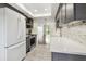 Renovated kitchen offering modern appliances and countertops with a view of the exterior from the pass-through at 5817 Park N St # 310, St Petersburg, FL 33709