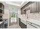 Modern kitchen featuring gray cabinets, stainless steel appliances, white countertops, and stylish backsplash at 5817 Park N St # 310, St Petersburg, FL 33709
