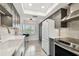 Updated kitchen with stainless appliances, granite countertops, and gray shaker cabinets at 5817 Park N St # 310, St Petersburg, FL 33709