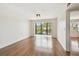 Open living room featuring hardwood floors, balcony access, and large windows at 5817 Park N St # 310, St Petersburg, FL 33709