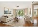 Bright and airy living room with stylish furnishings, balcony access, and wood floors at 5817 Park N St # 310, St Petersburg, FL 33709