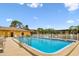 Community pool with bright blue water and surrounding lounge chairs at 5817 Park N St # 310, St Petersburg, FL 33709