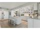 Bright and airy kitchen featuring a modern island with seating, stainless appliances, and updated white cabinetry at 5825 Puerta Del Sol S Blvd # 170, St Petersburg, FL 33715