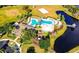 An aerial view of a community pool, playground, volleyball court and beautiful pond with fountain feature at 5925 Sweet William Ter, Land O Lakes, FL 34639