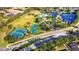 Aerial view of the community amenities including pool, tennis courts, and lakes at 5925 Sweet William Ter, Land O Lakes, FL 34639