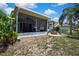 View of a covered patio, pergola, and fire pit in the backyard at 5925 Sweet William Ter, Land O Lakes, FL 34639