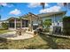 A backyard featuring a pergola, a built-in fire pit, and well-maintained landscaping at 5925 Sweet William Ter, Land O Lakes, FL 34639