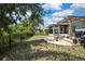 View of the backyard with a pergola, fire pit, and a black metal fence at 5925 Sweet William Ter, Land O Lakes, FL 34639