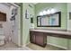 Half bathroom with tile floors, long vanity, and a framed mirror at 5925 Sweet William Ter, Land O Lakes, FL 34639