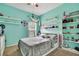 Bedroom featuring light blue painted walls, carpet floors, ceiling fan, and shelves at 5925 Sweet William Ter, Land O Lakes, FL 34639