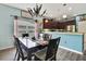 Inviting dining room with modern chandelier and views into the kitchen with stainless steel appliances at 5925 Sweet William Ter, Land O Lakes, FL 34639