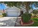 Charming single-story home with mature landscaping, inviting curb appeal, and an attached two-car garage at 5925 Sweet William Ter, Land O Lakes, FL 34639