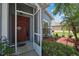 Inviting entryway featuring a stylish front door, screen door, and decorative landscaping adding to curb appeal at 5925 Sweet William Ter, Land O Lakes, FL 34639