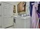 Practical laundry room with a washer, dryer, storage cabinet and hanging rack at 5925 Sweet William Ter, Land O Lakes, FL 34639