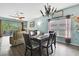 Open-concept living and dining area with sliding glass doors to the outdoor space and modern decor at 5925 Sweet William Ter, Land O Lakes, FL 34639