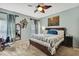 Spacious main bedroom featuring a ceiling fan, carpet floors, and light blue painted walls at 5925 Sweet William Ter, Land O Lakes, FL 34639