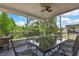 Covered outdoor patio with a dining table set and views of the landscaped backyard at 5925 Sweet William Ter, Land O Lakes, FL 34639
