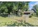Fenced backyard featuring a patio area, lush lawn, and mature trees at 5960 Boyette Rd, Wesley Chapel, FL 33545