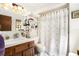 A bathroom with a single vanity and floral shower curtain at 5960 Boyette Rd, Wesley Chapel, FL 33545