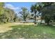 Front exterior of a home with a large lawn, cars parked in the driveway at 5960 Boyette Rd, Wesley Chapel, FL 33545