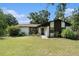 Charming one-story home with a well-maintained lawn and mature trees in a serene setting at 5960 Boyette Rd, Wesley Chapel, FL 33545