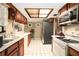 Well-lit kitchen with wood cabinetry, white countertops, and modern appliances for easy meal prep at 5960 Boyette Rd, Wesley Chapel, FL 33545