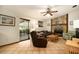 A cozy living room featuring a stone fireplace and tile flooring leading to a sunroom at 5960 Boyette Rd, Wesley Chapel, FL 33545