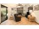 A living room featuring a stone fireplace, tile flooring, and natural light at 5960 Boyette Rd, Wesley Chapel, FL 33545