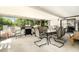 Enclosed patio with outdoor dining set, grill, and view of backyard at 5960 Boyette Rd, Wesley Chapel, FL 33545