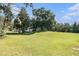 Expansive lot showcasing a home on a vast green lawn surrounded by trees at 5960 Boyette Rd, Wesley Chapel, FL 33545