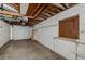 Spacious unfinished basement with white concrete block walls and a garage door at 6345 Lambert Ln, New Port Richey, FL 34652