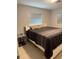 Cozy bedroom with tile floors, modern furnishings, and plenty of natural light at 6345 Lambert Ln, New Port Richey, FL 34652
