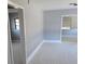 Bright living room features tile floors and fresh paint, creating a modern and airy space at 6345 Lambert Ln, New Port Richey, FL 34652