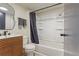 Modern bathroom featuring stylish vanity, patterned wallpaper and combined shower-tub at 6370 1St N St # 202, St Petersburg, FL 33702