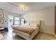 Bright bedroom with a comfortable bed and access to a private balcony with outdoor views at 6370 1St N St # 202, St Petersburg, FL 33702