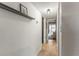 Inviting hallway featuring modern light fixture, floating shelf and neutral tile flooring at 6370 1St N St # 202, St Petersburg, FL 33702