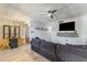 Open-concept living room with modern ceiling fan, mounted TV, and stylish dining area at 6370 1St N St # 202, St Petersburg, FL 33702
