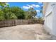 Large concrete backyard area with mature trees and a privacy fence at 6618 12Th N St, St Petersburg, FL 33702