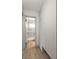 Hallway view into a compact bathroom with a shower/tub combination and white fixtures at 6618 12Th N St, St Petersburg, FL 33702