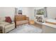 Cozy Bedroom with a wooden crib, comfortable recliner, and stylish decor at 6618 12Th N St, St Petersburg, FL 33702