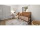 Bedroom featuring a wooden crib, neutral rug, and serene decor at 6618 12Th N St, St Petersburg, FL 33702