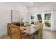Dining room with light wood floors, large windows with sheer curtains, a ceiling fan, and seating for six at 6618 12Th N St, St Petersburg, FL 33702