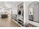Stylish entryway with built-in shelving, modern mirror, and light wood flooring at 6618 12Th N St, St Petersburg, FL 33702