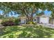 Charming single-story home featuring a manicured lawn and mature trees providing ample shade at 6618 12Th N St, St Petersburg, FL 33702