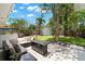 Backyard patio with an outdoor sectional sofa, coffee table, and overhead string lights at 6618 12Th N St, St Petersburg, FL 33702