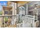 Comfortable balcony featuring rocking chairs and a view into the home's living room at 7523 Pitch Pine Cir # 184, Tampa, FL 33617