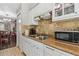 A kitchen showcasing white cabinets and appliances, paired with tile backsplash and countertops at 7523 Pitch Pine Cir # 184, Tampa, FL 33617