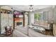 Comfortable living area with a fireplace, ceiling fan, wood floors, and access to a balcony at 7523 Pitch Pine Cir # 184, Tampa, FL 33617