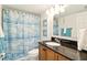 Bathroom with a vanity, granite countertop, toilet, and a shower with a mermaid-themed curtain at 7625 Sun Island S Dr # 304, South Pasadena, FL 33707