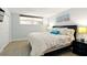 Comfortable bedroom featuring a queen-size bed, light wood floors, and a window for natural light at 7625 Sun Island S Dr # 304, South Pasadena, FL 33707